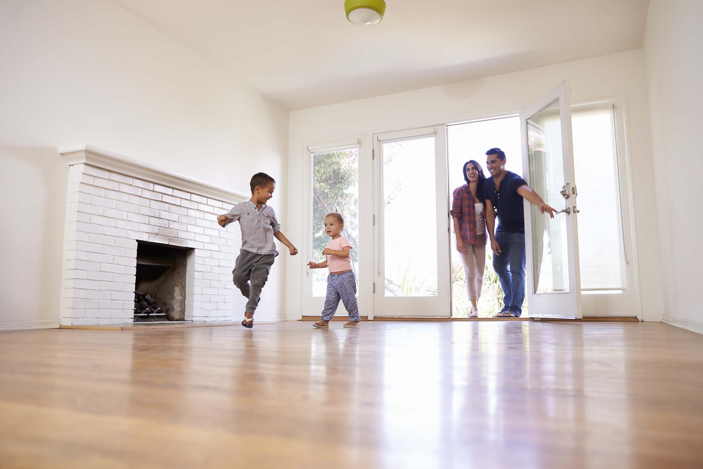 Children playing in home with their parents inside an Interior painted home done by Connected painters in Winnipeg